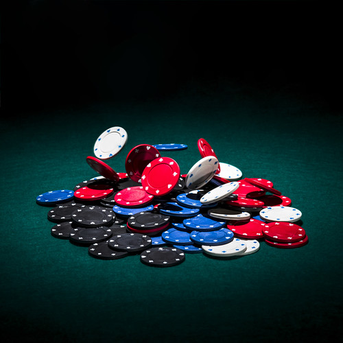 multicolor-casino-chips-green-poker-table_23-2147881553